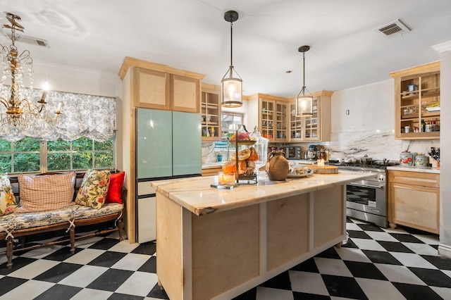 kitchen featuring high end range, a center island, tasteful backsplash, light brown cabinetry, and a chandelier