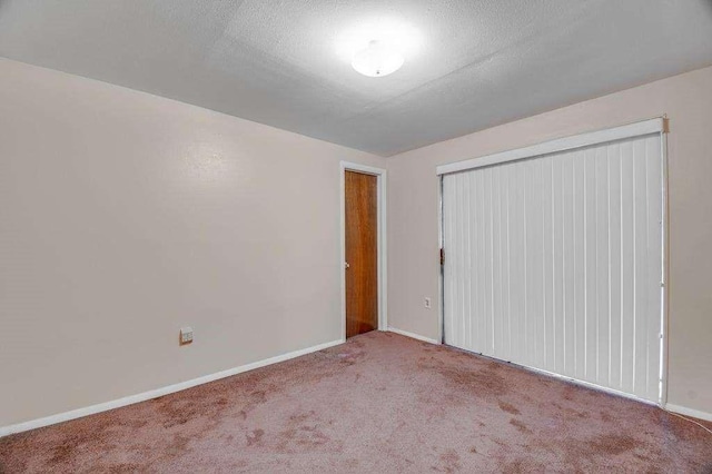 carpeted spare room featuring a textured ceiling