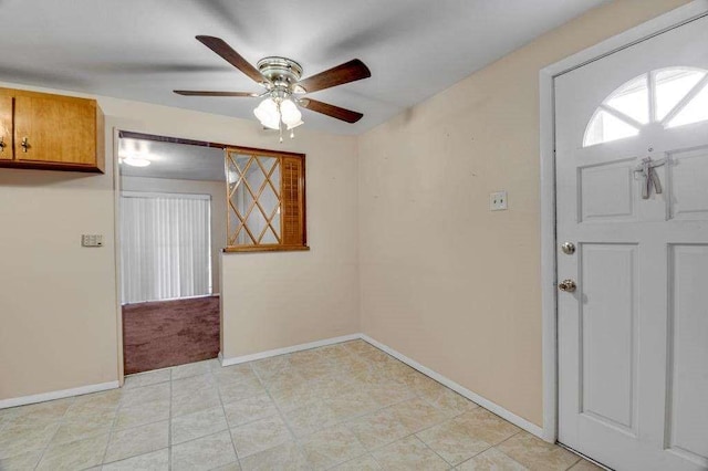 tiled foyer entrance featuring ceiling fan