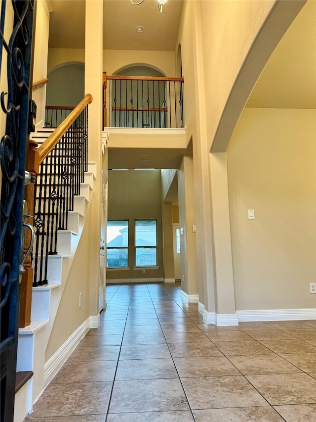 foyer featuring a towering ceiling