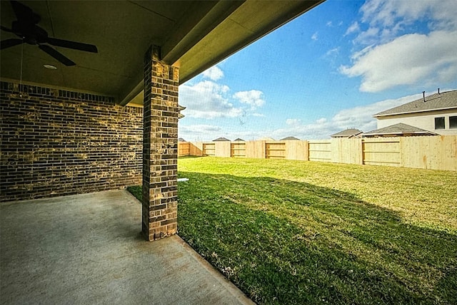 view of yard with ceiling fan and a patio area