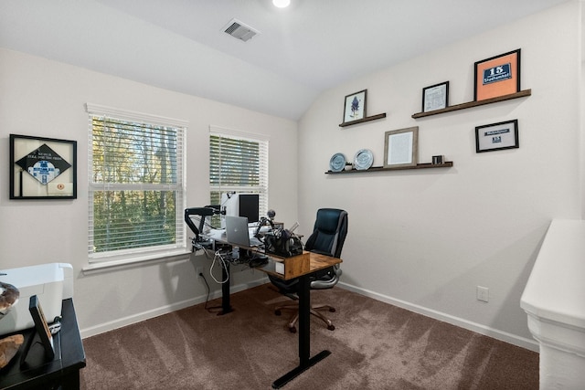 carpeted home office with vaulted ceiling