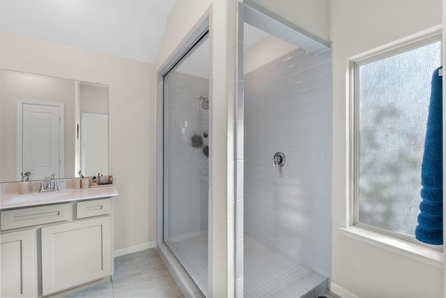 bathroom with a tile shower, tile patterned floors, and a healthy amount of sunlight