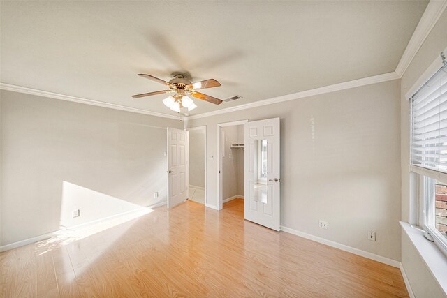 spare room featuring crown molding, ceiling fan, and light wood-type flooring