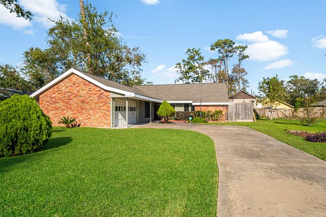 single story home with a front yard and a garage