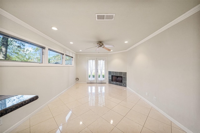 unfurnished living room featuring crown molding, french doors, ceiling fan, and light tile patterned floors