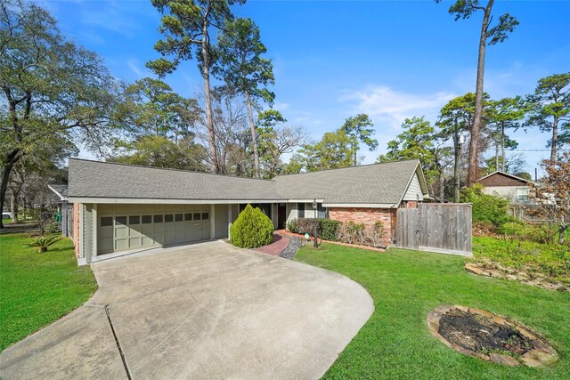 ranch-style house featuring a garage and a front lawn