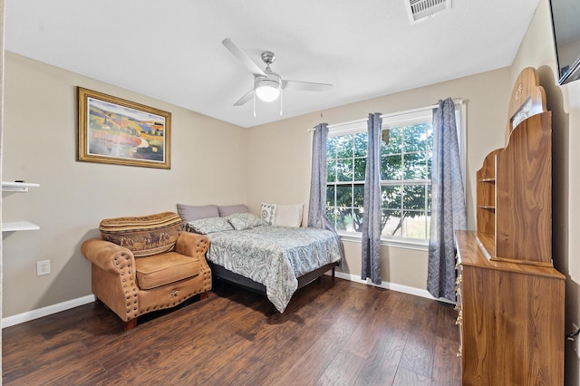 bedroom with dark hardwood / wood-style flooring and ceiling fan