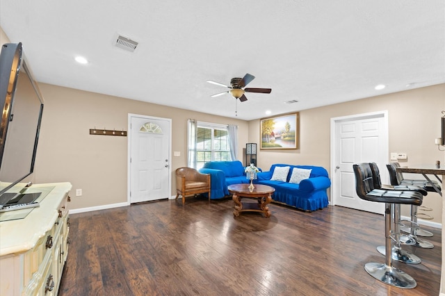 living room with dark hardwood / wood-style floors and ceiling fan