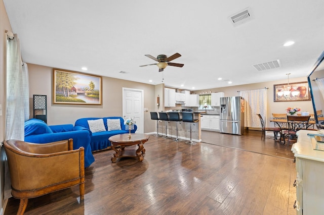 living room with dark hardwood / wood-style flooring and ceiling fan