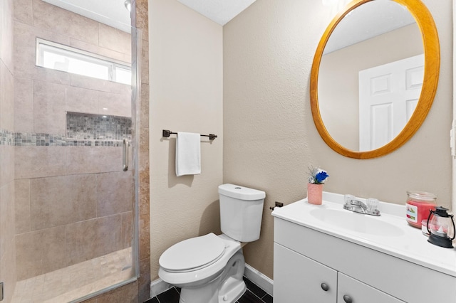 bathroom with vanity, toilet, and a shower with door