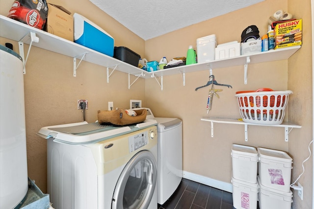 washroom featuring independent washer and dryer, a textured ceiling, and dark wood-type flooring