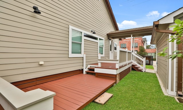 wooden terrace featuring a lawn