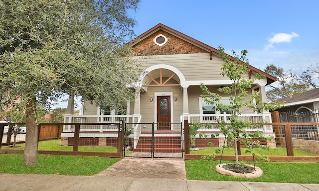 bungalow featuring a porch and a front yard