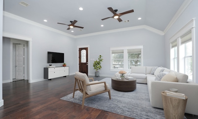 living room with dark hardwood / wood-style flooring, crown molding, a wealth of natural light, and vaulted ceiling