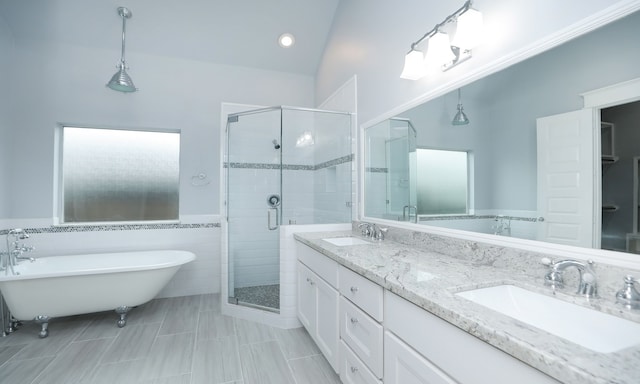 bathroom with separate shower and tub, tile walls, vanity, and lofted ceiling