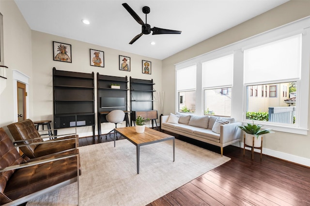 living room featuring dark hardwood / wood-style flooring and ceiling fan