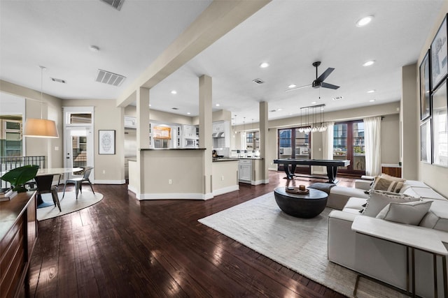 living room featuring ceiling fan, dark hardwood / wood-style flooring, and pool table