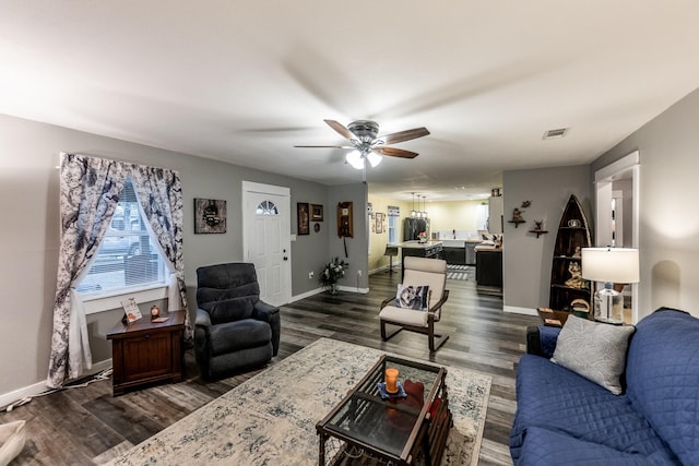 living room with dark hardwood / wood-style floors and ceiling fan