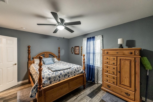 bedroom with hardwood / wood-style floors and ceiling fan