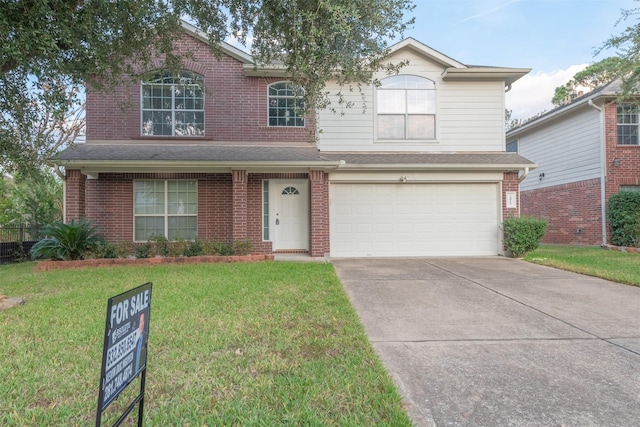 view of property featuring a front lawn and a garage