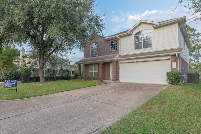 view of front of property featuring a front yard and a garage