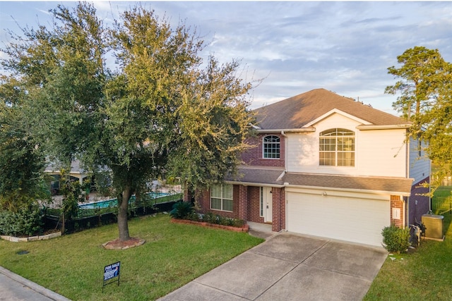 view of front of home with a front yard and a garage