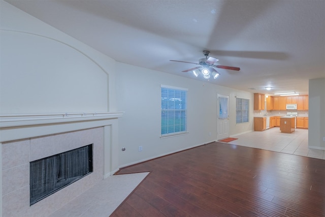 unfurnished living room with ceiling fan and light hardwood / wood-style floors