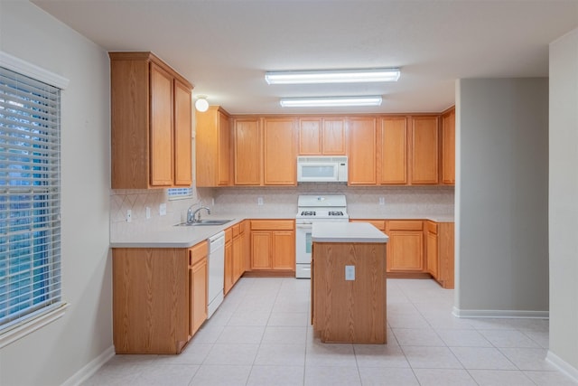 kitchen featuring sink, light brown cabinets, white appliances, decorative backsplash, and a kitchen island