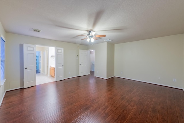 unfurnished room with a textured ceiling, dark hardwood / wood-style floors, and ceiling fan