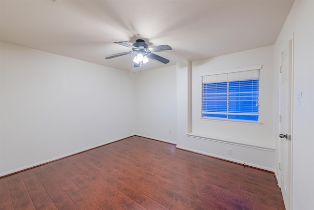 spare room with ceiling fan and dark wood-type flooring