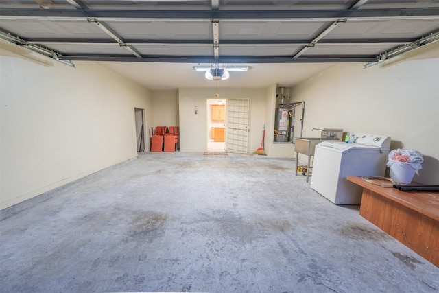 garage featuring separate washer and dryer, a garage door opener, water heater, and sink