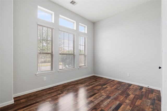 spare room featuring dark hardwood / wood-style flooring