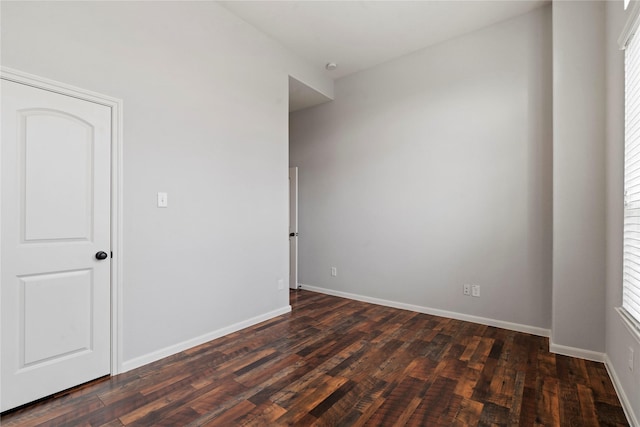 unfurnished room featuring dark wood-type flooring