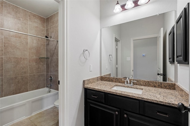 full bathroom featuring vanity, toilet, and tiled shower / bath