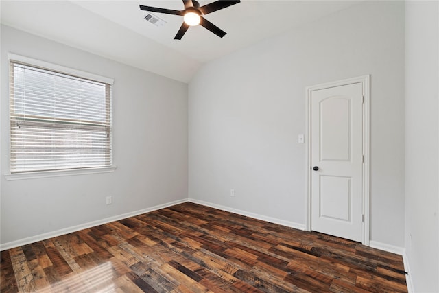 empty room featuring ceiling fan, dark hardwood / wood-style flooring, and vaulted ceiling