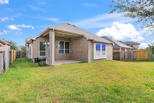 back of house featuring a yard and a patio