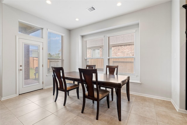 dining area with a wealth of natural light and light tile patterned floors