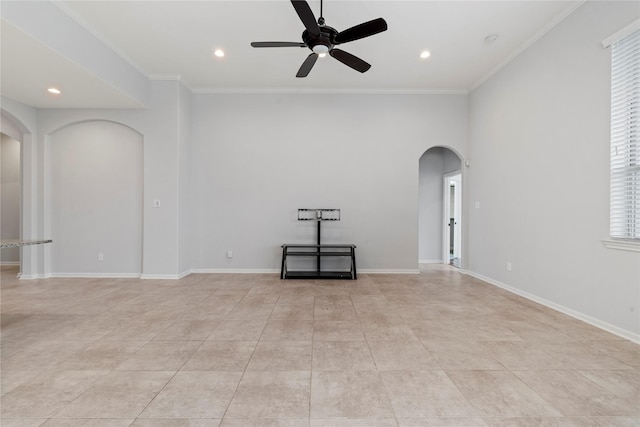 empty room with ceiling fan and crown molding