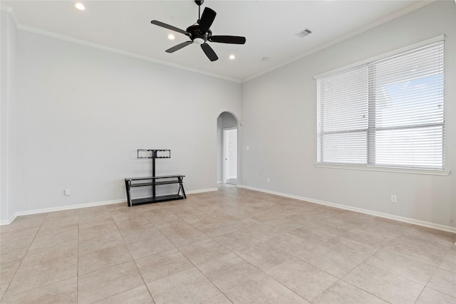 tiled empty room featuring ceiling fan and ornamental molding