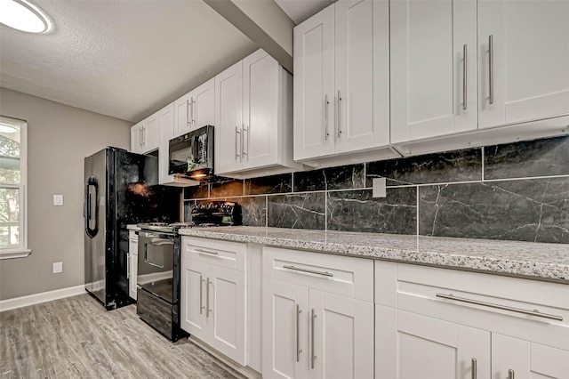 kitchen with light wood-type flooring, tasteful backsplash, a textured ceiling, black appliances, and white cabinetry