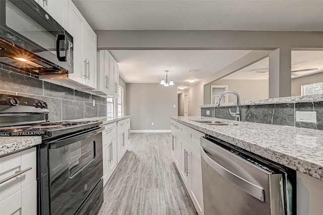 kitchen featuring black appliances, white cabinets, sink, light hardwood / wood-style flooring, and light stone counters