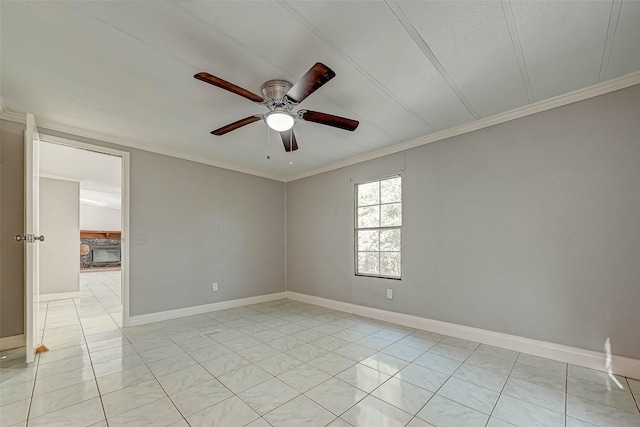 tiled empty room with ceiling fan and crown molding