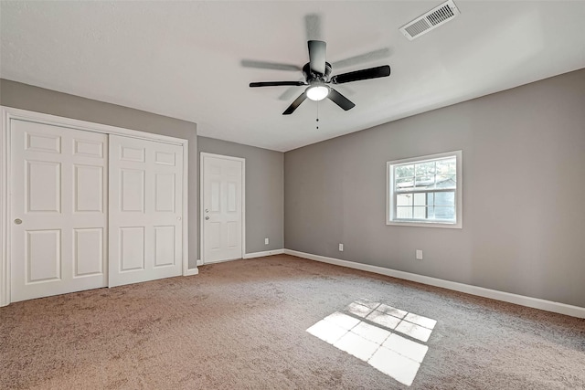 unfurnished bedroom featuring ceiling fan and carpet floors