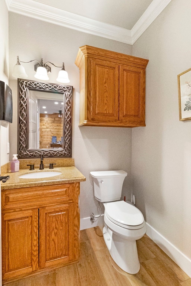 bathroom featuring vanity, toilet, and crown molding