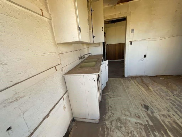 kitchen featuring white cabinets, dark hardwood / wood-style flooring, and sink