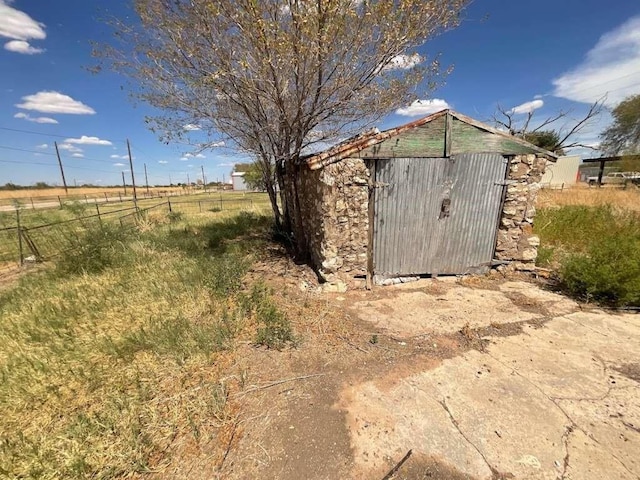 view of outdoor structure with a rural view