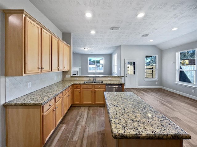 kitchen featuring hardwood / wood-style floors, a textured ceiling, and a healthy amount of sunlight