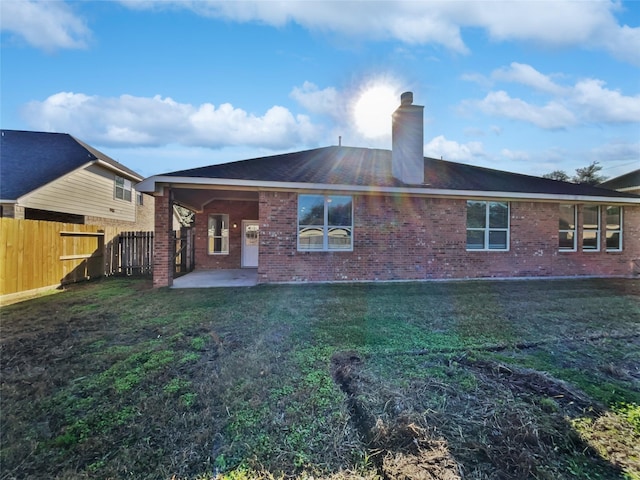 rear view of property with a yard and a patio