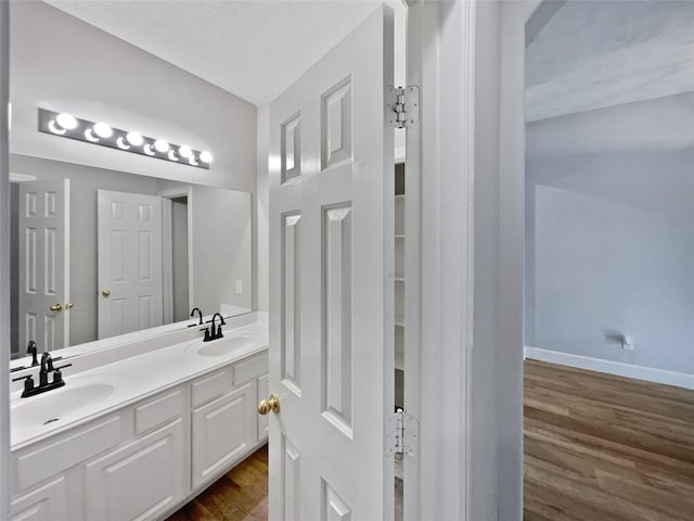 bathroom with wood-type flooring and vanity